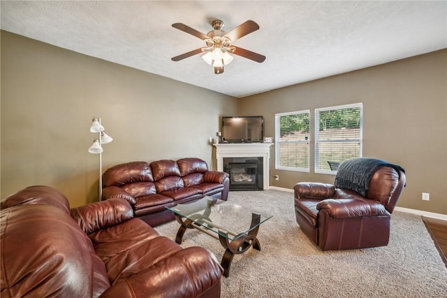 living room with ceiling fan and a textured ceiling