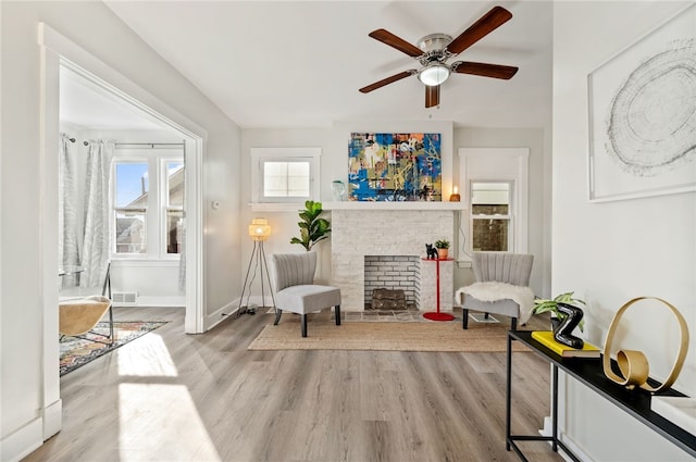 sitting room with ceiling fan and light hardwood / wood-style flooring