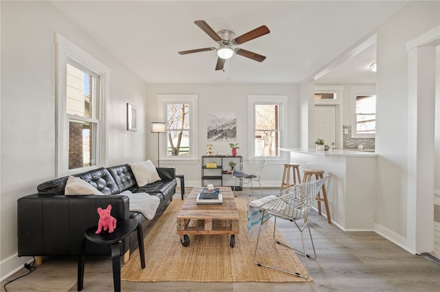 living room featuring ceiling fan and light wood-type flooring