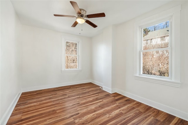 empty room featuring ceiling fan and dark hardwood / wood-style flooring