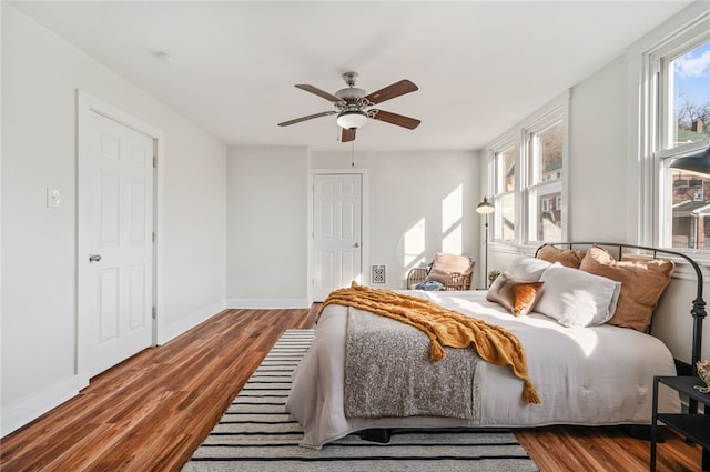 bedroom featuring ceiling fan and dark hardwood / wood-style flooring