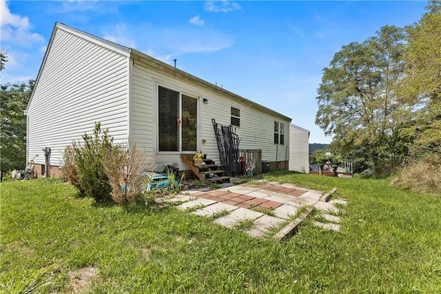 rear view of property with a yard