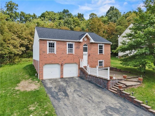 split foyer home featuring a garage and a front lawn