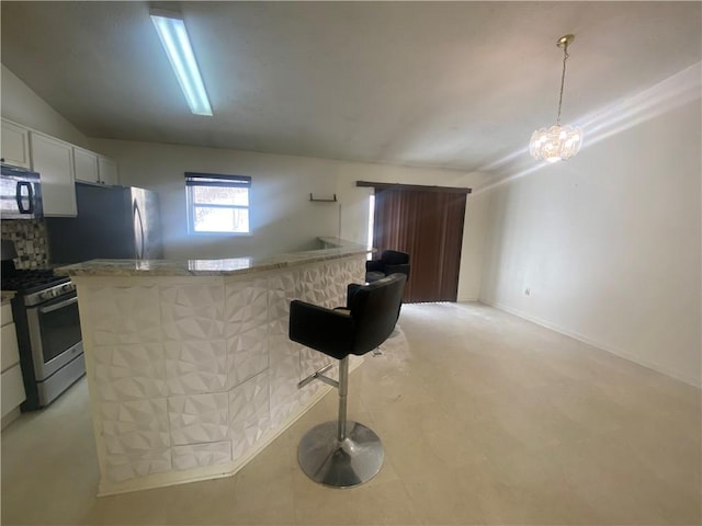 kitchen featuring hanging light fixtures, light stone counters, a chandelier, white cabinets, and appliances with stainless steel finishes