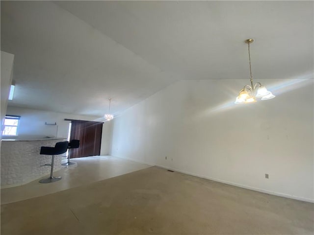 unfurnished living room featuring lofted ceiling and a notable chandelier