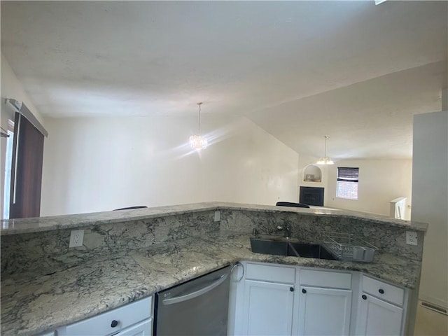 kitchen featuring white cabinetry, sink, light stone counters, stainless steel dishwasher, and vaulted ceiling