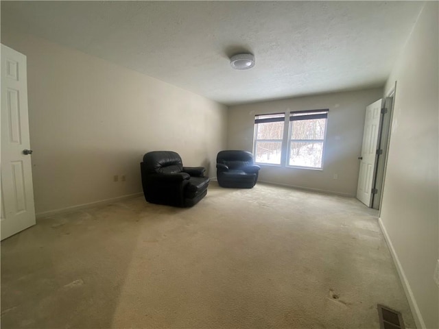 unfurnished room featuring light carpet