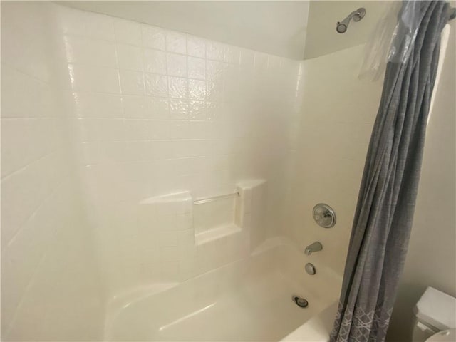 bathroom with shower / bath combo and toilet