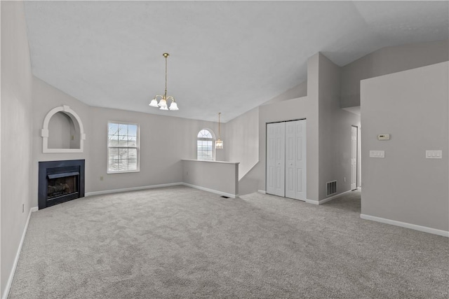 unfurnished living room with light colored carpet, vaulted ceiling, baseboards, and an inviting chandelier