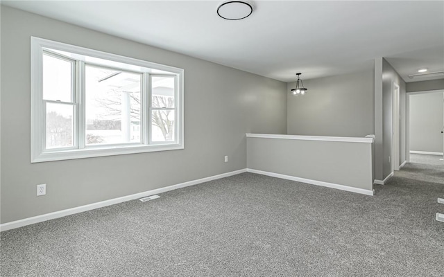 spare room with dark carpet