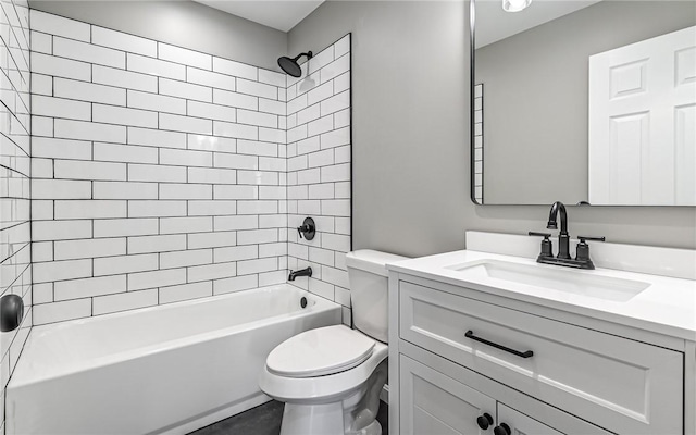 full bathroom featuring toilet, vanity, and tiled shower / bath