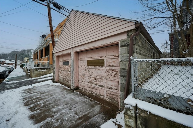 exterior space with a garage and an outdoor structure