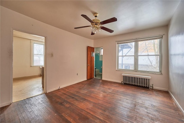 unfurnished room with ceiling fan, a healthy amount of sunlight, dark wood-type flooring, and radiator