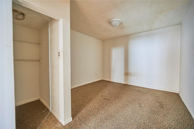 unfurnished bedroom with a closet and dark carpet