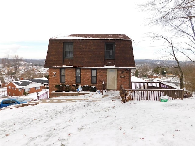 view of snow covered rear of property