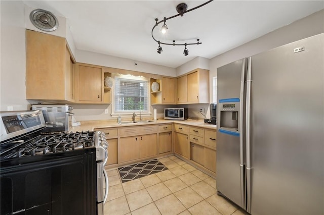 kitchen featuring appliances with stainless steel finishes, light tile patterned floors, light brown cabinetry, and sink