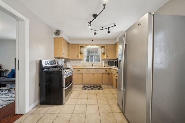 kitchen with light brown cabinets, light tile patterned floors, and stainless steel appliances