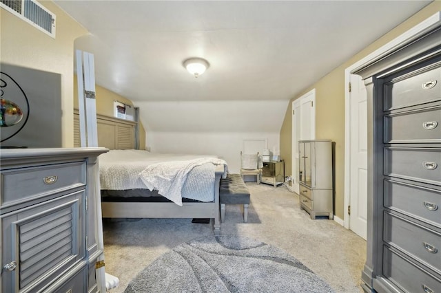 bedroom featuring light colored carpet and vaulted ceiling