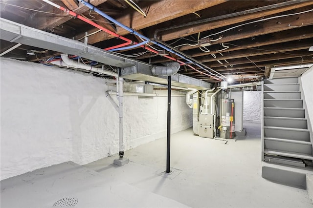 basement featuring heating unit and water heater