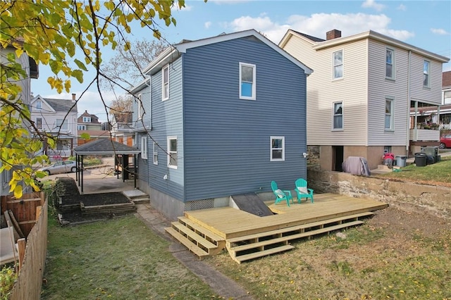 back of house featuring a gazebo and a deck