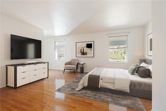 bedroom featuring light wood-type flooring and multiple windows