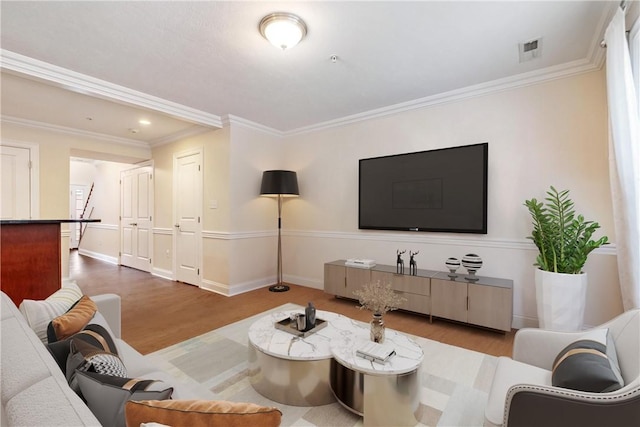 living room with wood-type flooring and crown molding