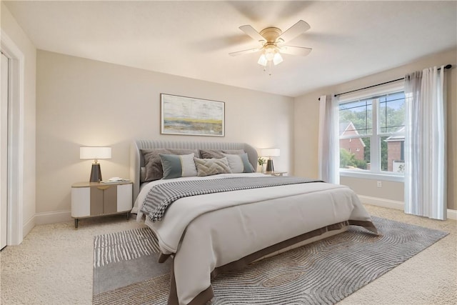 bedroom with ceiling fan and light colored carpet