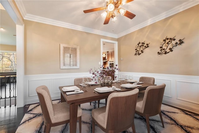 dining space with dark hardwood / wood-style flooring and crown molding