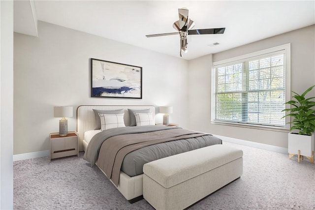 bedroom featuring light colored carpet and ceiling fan