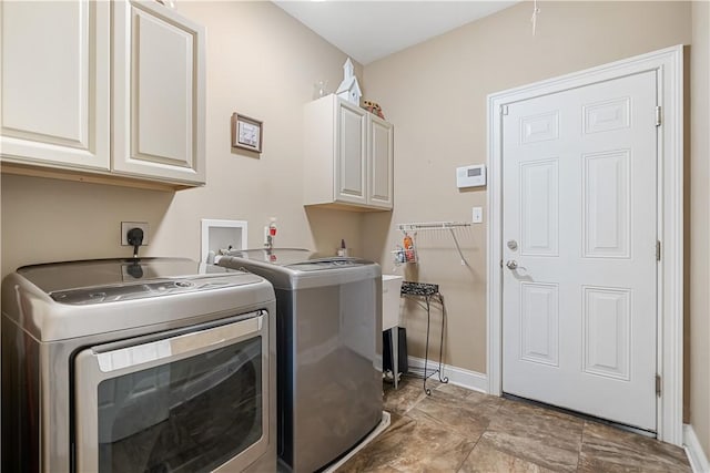 laundry area featuring separate washer and dryer and cabinets