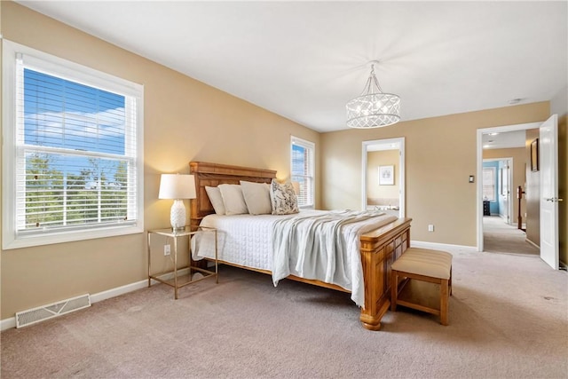 bedroom with carpet flooring and a notable chandelier