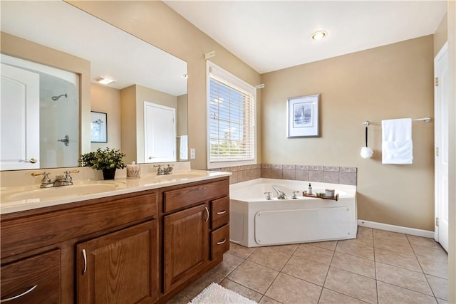 bathroom with a tub, tile patterned flooring, and vanity