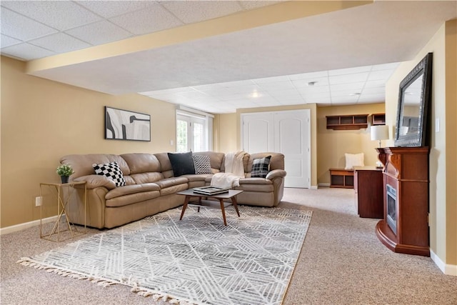 living room with carpet floors and a drop ceiling