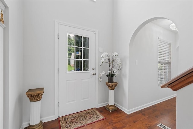 entryway with dark hardwood / wood-style flooring