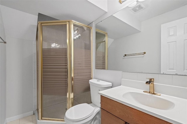 bathroom with tile patterned flooring, vanity, toilet, and walk in shower