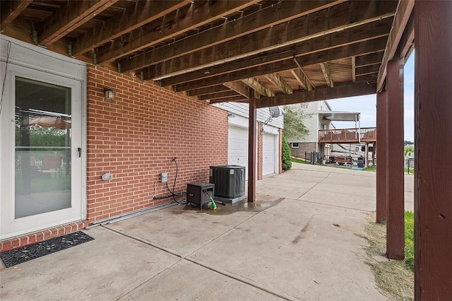 view of patio / terrace featuring central AC unit and a garage