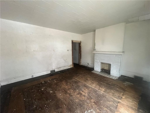 unfurnished living room with a stone fireplace