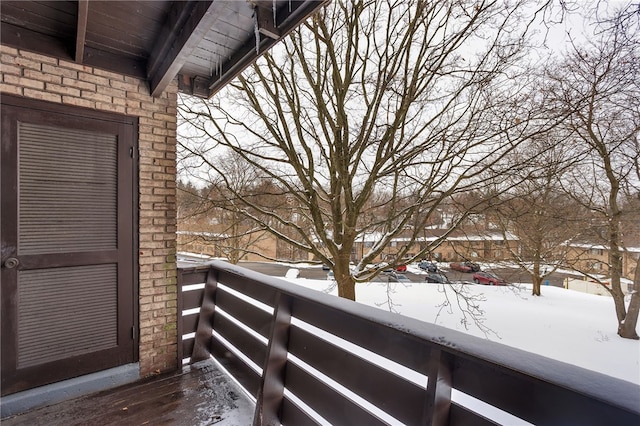 view of snow covered back of property