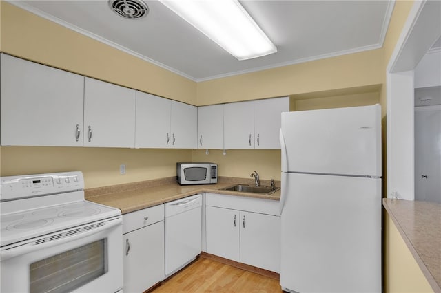 kitchen featuring ornamental molding, sink, white cabinets, and white appliances