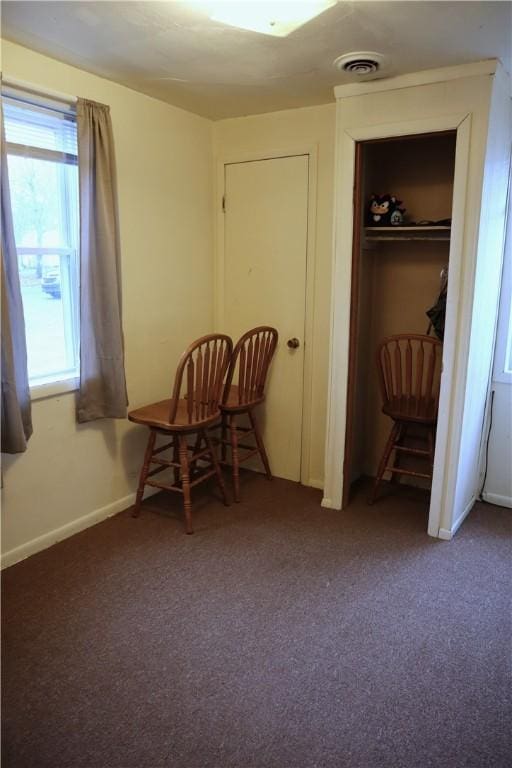 sitting room with dark colored carpet