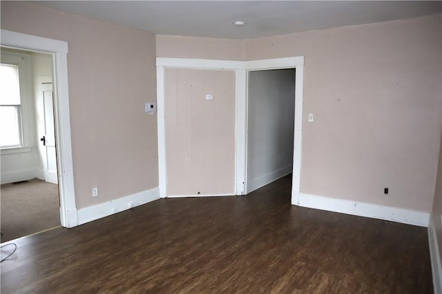 unfurnished room featuring dark wood-type flooring