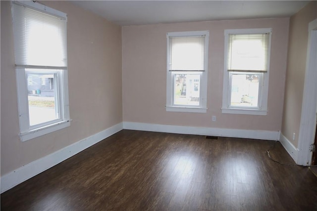 empty room with dark hardwood / wood-style floors