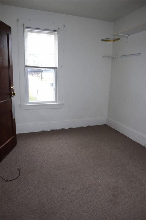 carpeted spare room with a healthy amount of sunlight