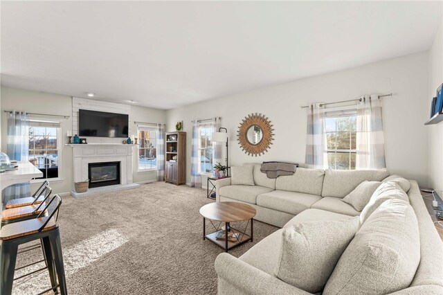 carpeted living room featuring a fireplace