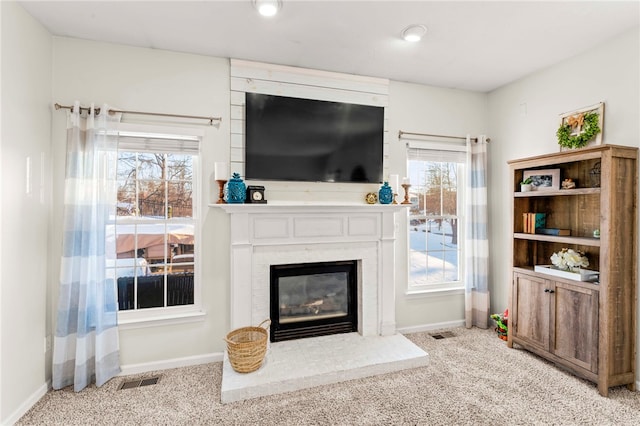 living room featuring light carpet and a brick fireplace