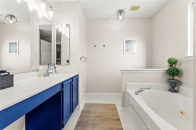 bathroom featuring vanity, tile patterned floors, and a bathing tub