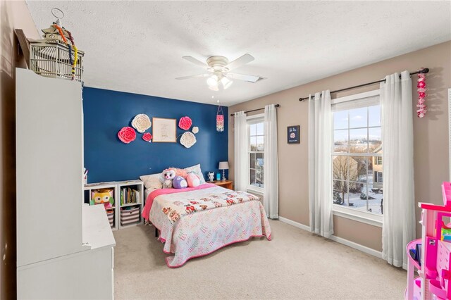 bedroom with carpet flooring, a textured ceiling, and ceiling fan