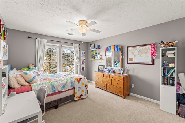 carpeted bedroom with a textured ceiling and ceiling fan