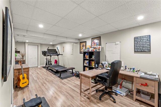 office featuring hardwood / wood-style flooring and a drop ceiling