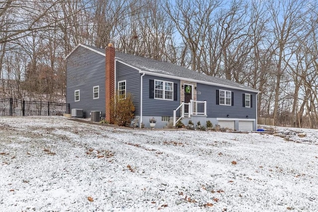 view of front of home featuring central AC unit and a garage